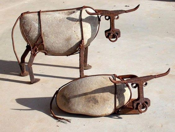 Cattle made from river rock, railroad spikes, railroad track, steel wire, and nuts 