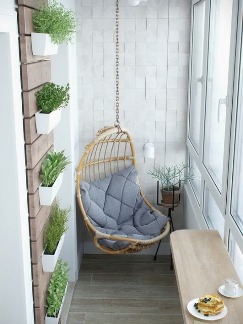 A small balcony with a swinging chair