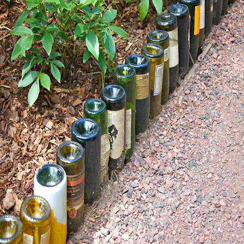 Use wine bottles as a barrier to stop kids from stepping on the seedlings.