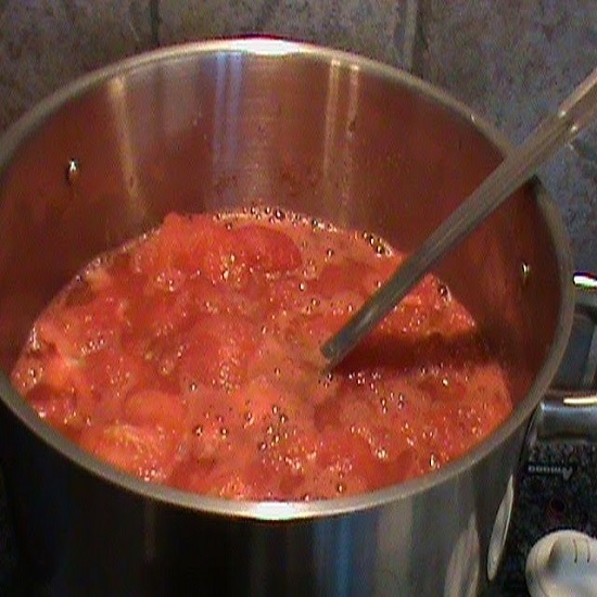 Place the tomatoes in the pot and cook them down
